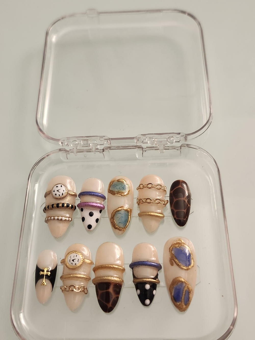 Assorted Nail Art Press-Ons in Neutral, Blue, Black and Gold Accents